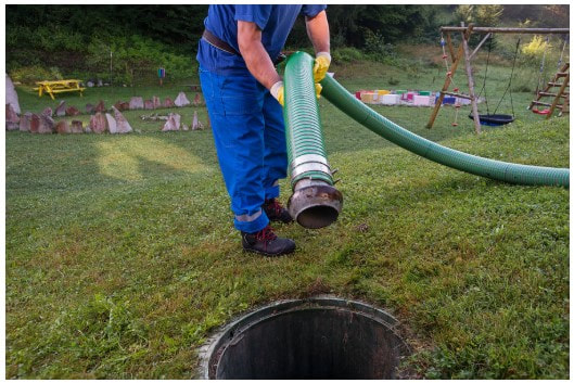 Septic pump hose being inserted into tank